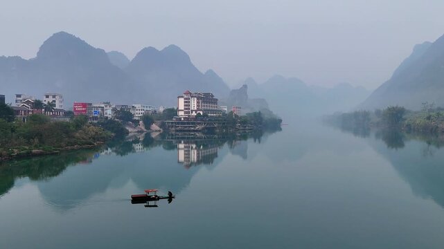 Yao Ethnic Fisherman Casting Net on Hongshui River at Dawn, Guangxi, China