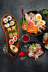 Table served with sushi and traditional japanese food.