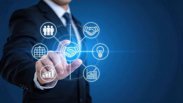 Businessman touching virtual handshake icon with connected business symbols,partnership agreement and corporate collaboration network concept on blue background