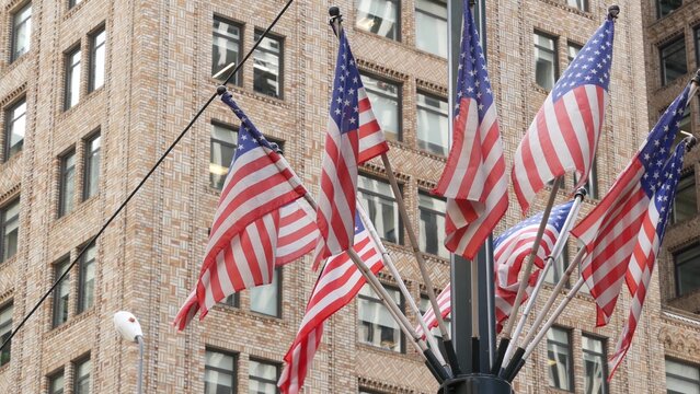 American flags near Grand Central Terminal on 42 street, New York City, Manhattan Midtown. Urban building architecture in United States. Typical offices windows of brick tower. Pershing square in NYC.