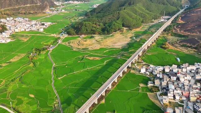 High-Speed Train in Guangxi&lsquo;s Ethnic Minority Mountain Region with Green Fields