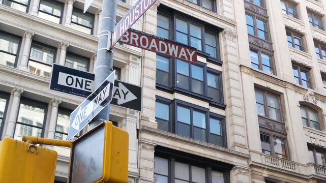 New York City Broadway street sign in Lower Manhattan, United States. Urban road sign in american city. Traffic sign in NYC USA. Building architecture in West Village district near Soho. One way arrow