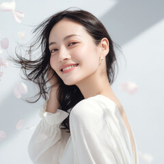 美しい肌の女性と桜が舞う春の背景