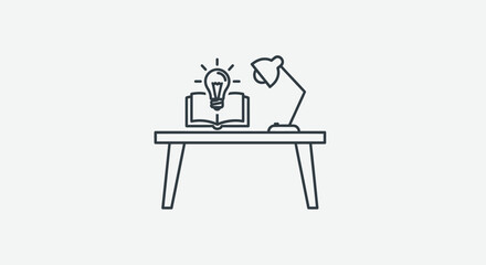 Fototapeta premium Desk with Open Book and Glowing Light Bulb Symbolizing Idea.