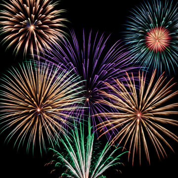 A grand finale of fireworks in a variety of colors, with the lower part of the scene kept dark for copy space.