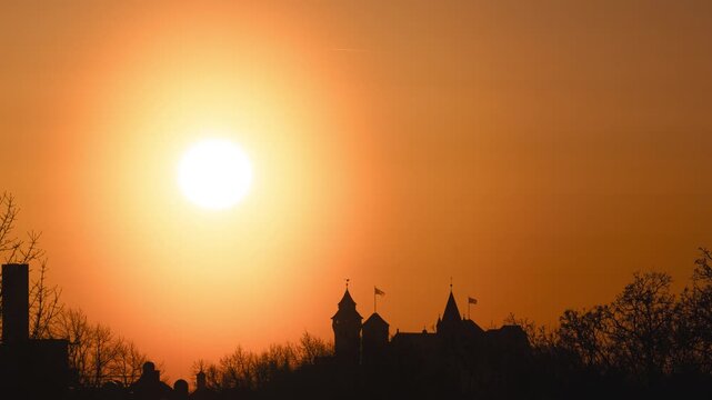 Sunset behind the silhouette of Nuremberg's historic castle. Twice a year, the sun sets exactly behind this landmark.