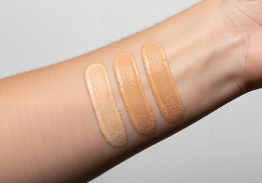 Skin patch test on wrist with foundation swatches for tone match  