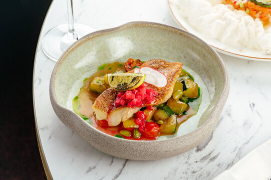 fried pike perch fillet with sauce and vegetable stew