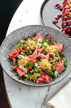 salad with beef, blue cheese, herbs and sauce