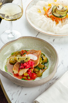 fried pike perch fillet with sauce and vegetable stew