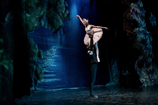 classical ballet dancer performing on stage with partner.