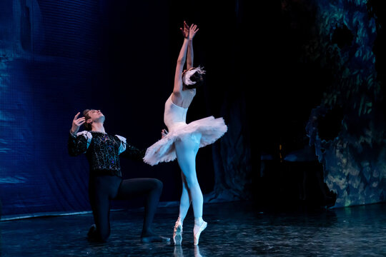 classical ballet dancer in white tutu performing  with partner.