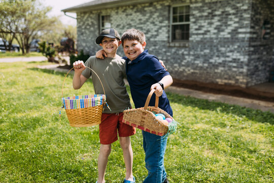 Boys smiling with Easter baskets at family celebration