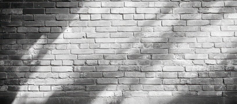 monochrome brick wall with dappled sunlight and soft leaf shadows conveying a quiet textured mood