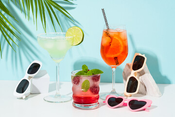 Margarita, Aperol Spritz and strawberry mojito at blue background.