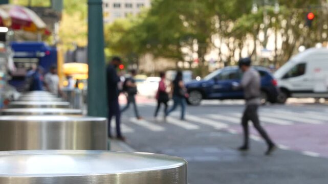 Sixth 6 avenue and 42nd street crossroad, Bryant park in Manhattan Midtown, New York City, United States of America. Defocused people pedestrians crossing on zebra near bank, yellow taxi car on road.