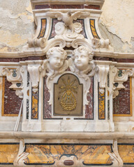 Naklejka premium SALERNO, ITALY - OCTOBER 6, 2025: The detail of baroque marble tabernacle form side altar of church Chiesa di San Giorgio by Pietro and Bartolomeo Ghetti from 17. cent.