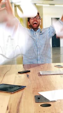 Vertical video: Man sorting papers while peer handing sheet in office, team tossing papers for fun