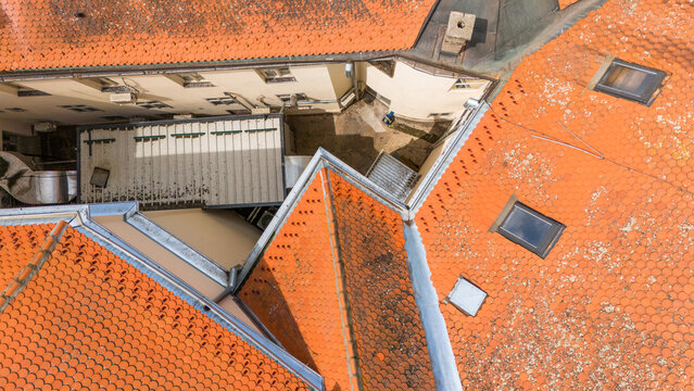 Aerial view of terracotta rooftops meeting in sharp angles, creating a geometric tapestry of textures and shades, Sremska Mitrovica, Vojvodina, Serbia.