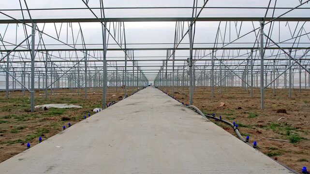 Symmetrical Perspective of Modern Steel Greenhouse Frame Under Construction