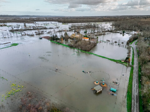 Isle-Saint-Georges, France - 20 February 2026: Aerial view of a landscape transformed into a vast, reflective lake, swallowing fields and trees under a somber sky.