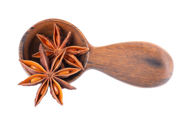 Star anise isolated on white background. Anise stars or badian spice in wooden spoon. Clipping path.