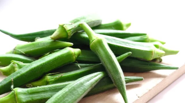 Fresh Raw Green Okra Ladies Fingers on Wooden Board White Background &mdash; Horizontal Food Photography Clip