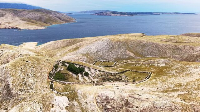 Top down drone view of rocky coastline and natural trails near Ba&scaron;ka on Krk island, Croatia. Concept of adventure travel, hiking exploration and untouched Mediterranean wilderness