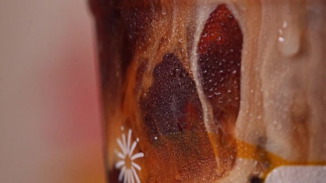 4K Macro close-up of fresh milk pouring into black coffee, creating smooth creamy swirls and rich brown patterns, Abstract liquid texture with dynamic motion perfect for beverage and refreshment conce