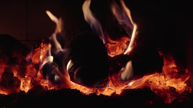 Log burning in a fireplace during a cozy evening