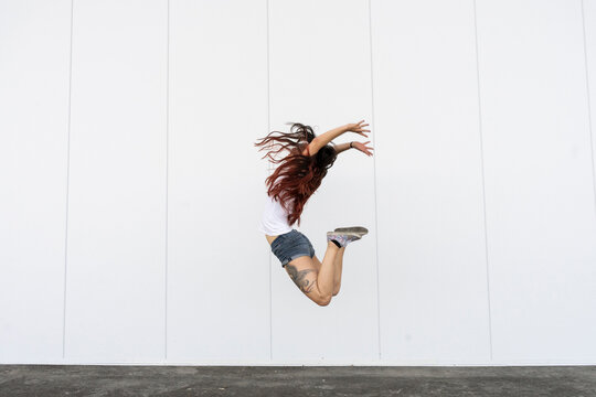 Young acrobat jumping in air
