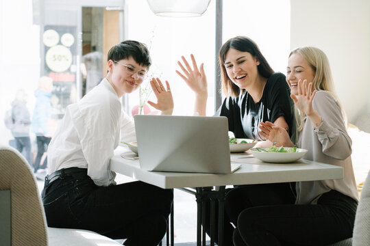 Friends having a video conference in a restaurant