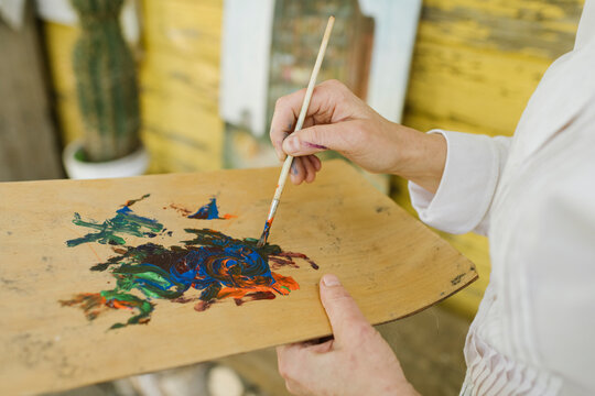 Hands of female artist mixing colours