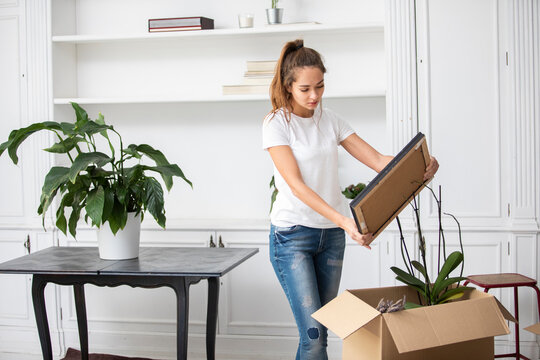 Woman packing cardboard boxes