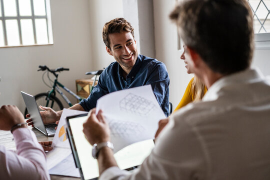 Confident business team having a meeting in loft office