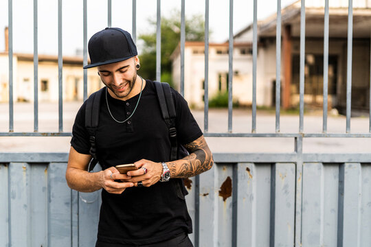 Young man using his smartphone in the city