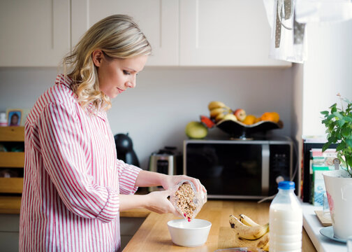 Woman preparing breakfast in the kitchen at home