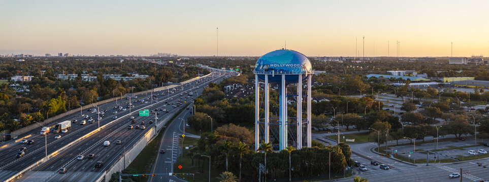 Aerial view of the iconic Hollywood water tower standing tall amidst a tapestry of green trees and bustling highways, Hollywood, Florida, United States.