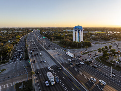 Aerial view of the iconic water tower gleaming against the setting sun, with cars streaming along the highway below, Hollywood, Florida, United States.