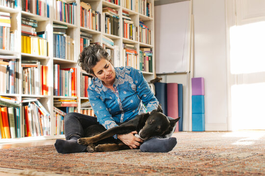 Woman with her dog on the floor at home