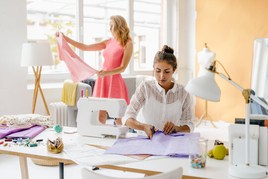 Two young women in fashion studio