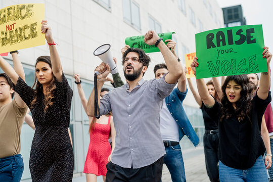 Multi ethnic activists protesting in city