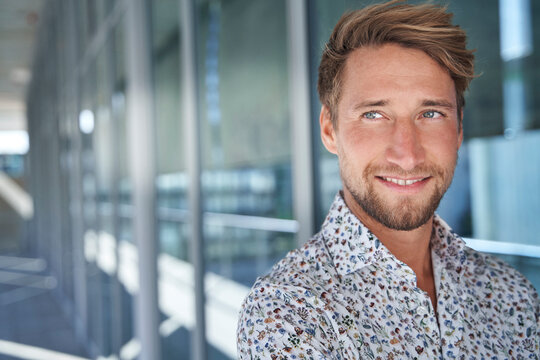 Portrait of smiling young man wearing patterned shirt