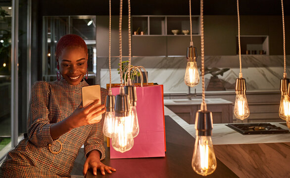 Young woman taking a selfie with her cell phone after shopping