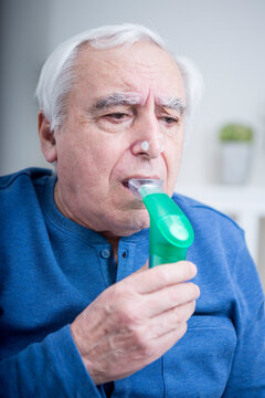 Senior man using nebuliser