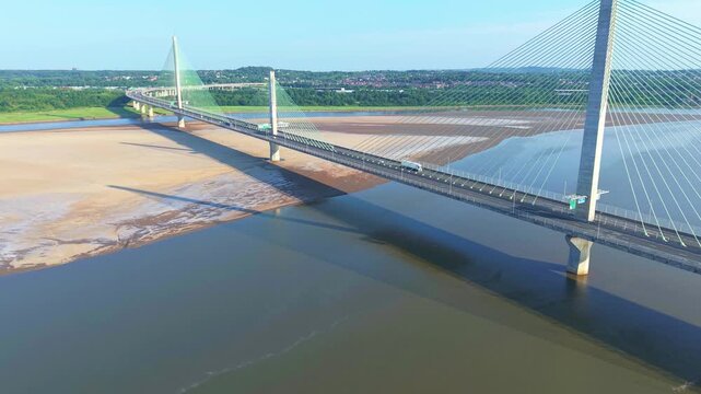 Liverpool, Merseyside, UK, June 19, 2025; Aerial 4K video footage of the Mersey Gateway toll bridge with stunning views over the River Mersey, Liverpool, UK.