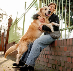 Golden Retriever Dog Hugging Owner During A Spring Walk