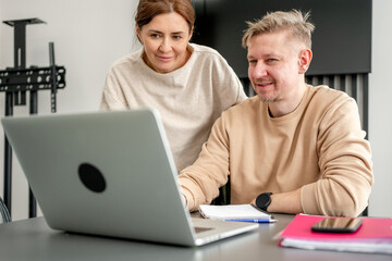 Man And Woman Working On Project With Laptop In Office