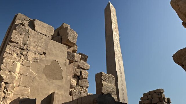 This low-angle clip captures the lone standing obelisk of Thutmose I, located between the fourth and fifth pylons of the Karnak Temple.