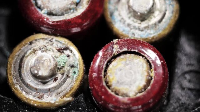 Rotating close up of heavily oxidized battery ends with visible chemical buildup
